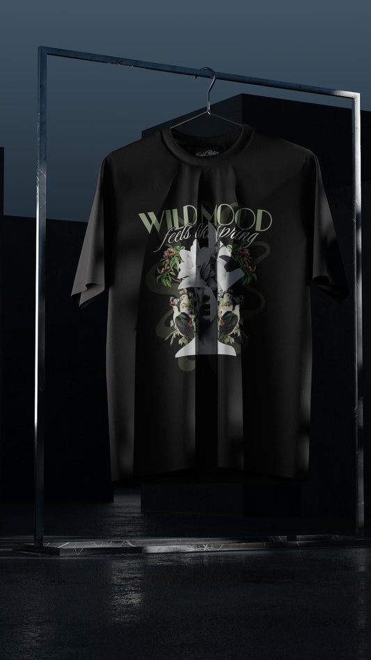 Black t-shirt with graphic design and text on a hanger against a dark background