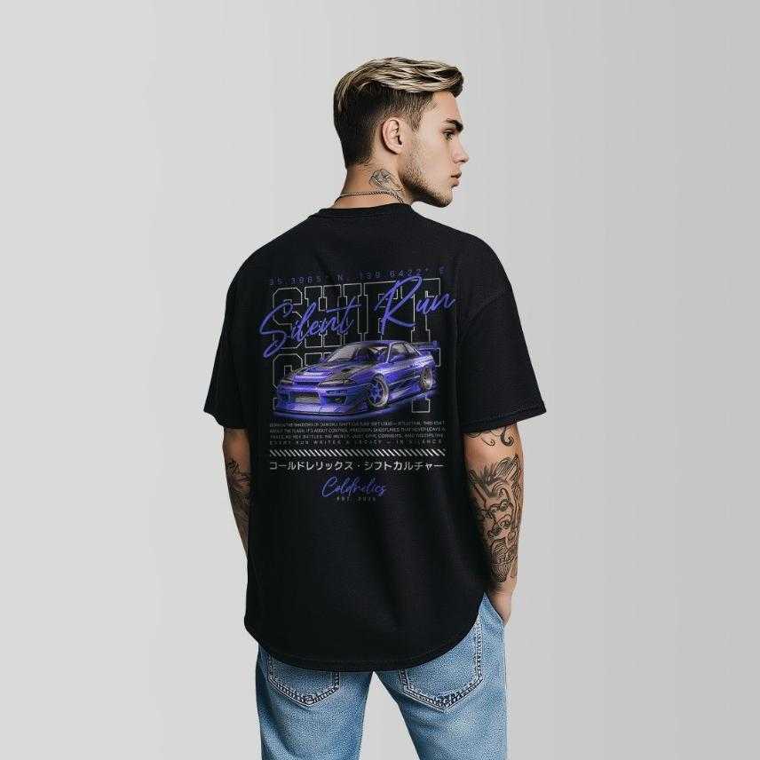 Person wearing a white t-shirt with Car graphic design and text on the back 'SILENT RUN' standing against a plain background by coldrelics